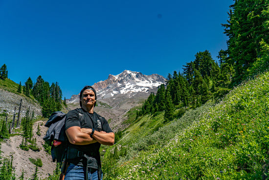 Fit and Healthy Man standing at the base of Mount Hood in Oregon. promoting Gains Everyday health food, protein snack, and fitness equipment store.